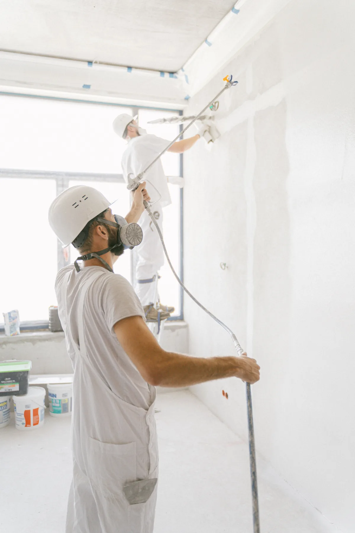 Stock photo of professional painters working on an interior wall